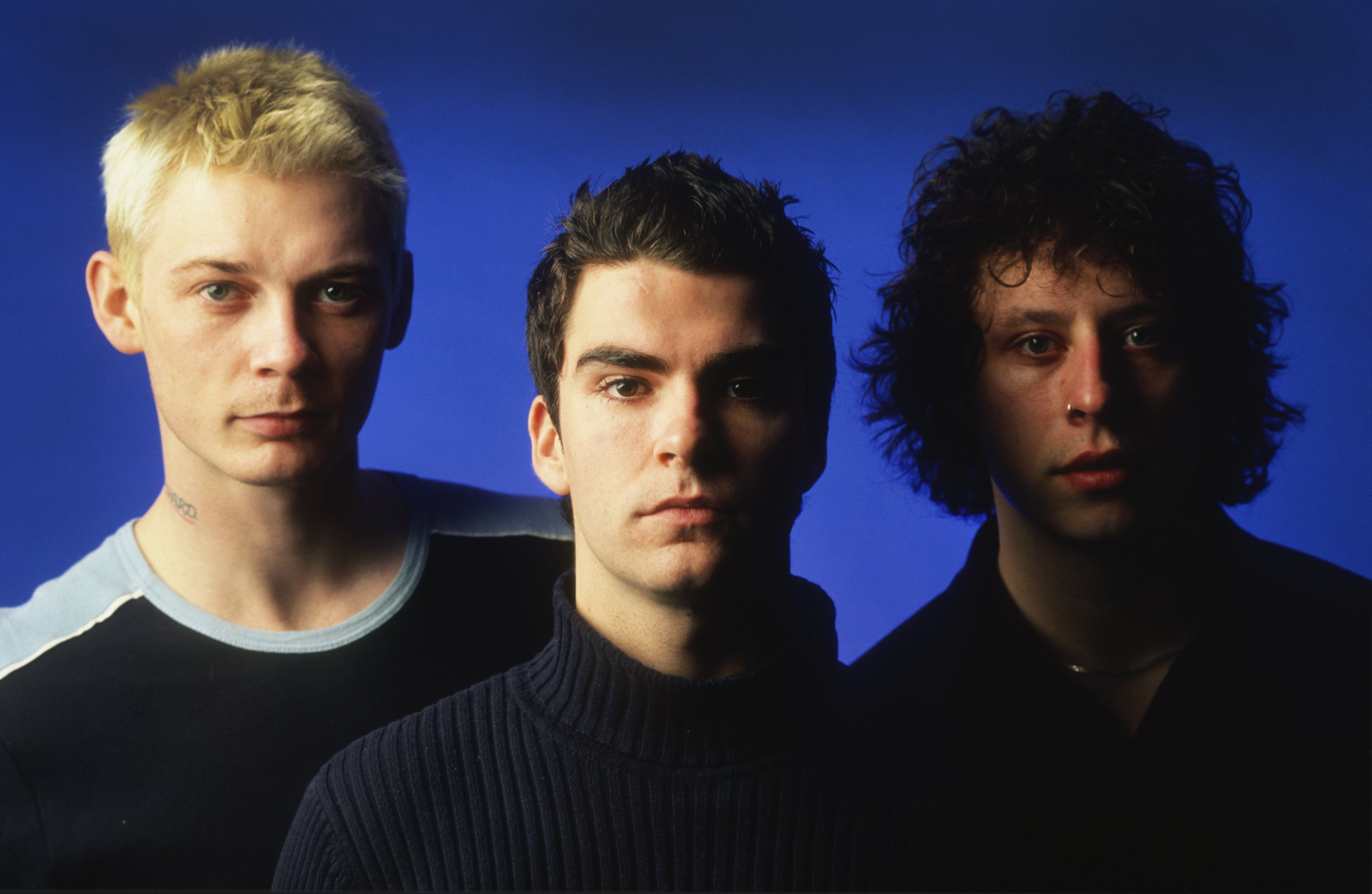 Studio portrait of Stereophonics against a blue background